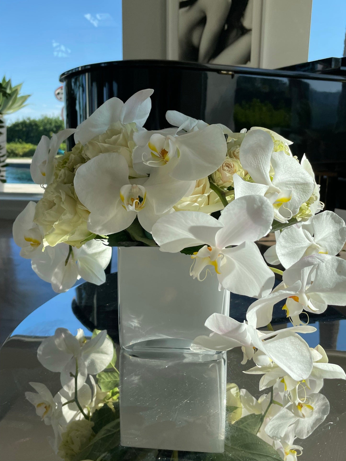 White orchids with white roses in a medium vase